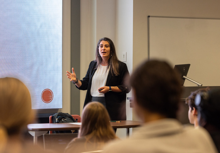 Professor Sahar Abi-Hassan lecturing to students in a classroom.
