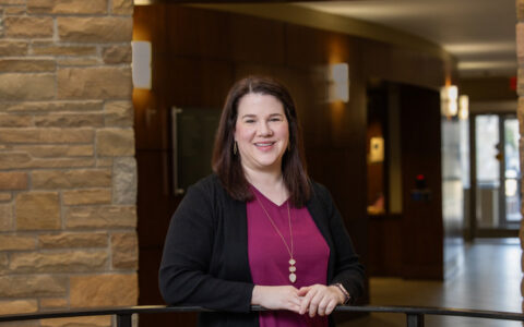 Portrait of a woman in a burgundy top and black cardigan, honoring Fern Holland's legacy.
