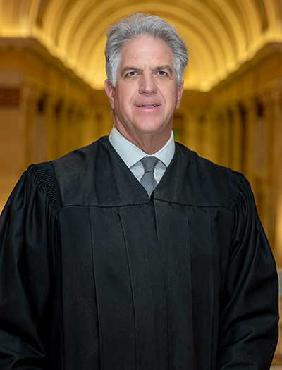 Judge James R. Huber in judicial robes, portrait for American Law Institute election.