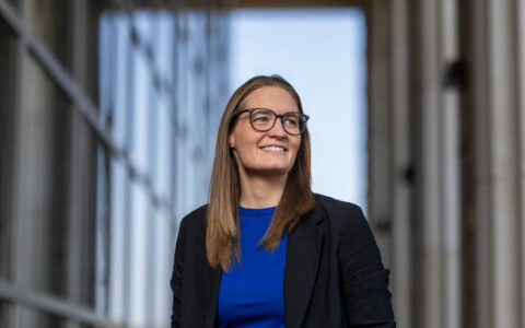 UTulsa transfer student in glasses and blazer smiles confidently. #UTulsaNonconventionalStudents