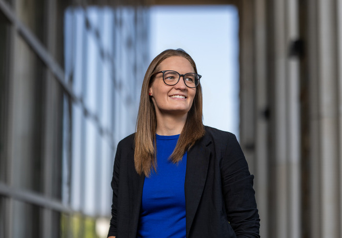 UTulsa transfer student in glasses and blazer smiles confidently. #UTulsaNonconventionalStudents