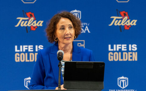 President-elect Stacy Leeds speaks at the University of Tulsa. "Life is Golden" is in the background.