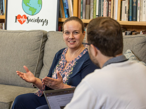 Professor discussing midterm grades with a student in an office setting