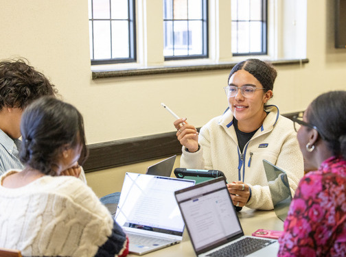 Students collaborating on laptops during a group study session