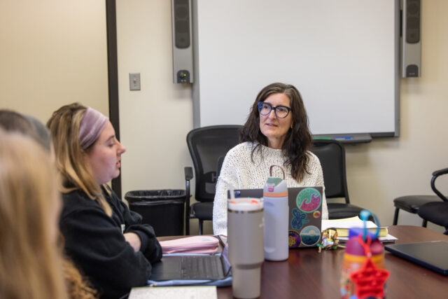 Professor Lisa Cromer meets with graduate students