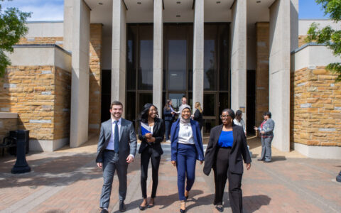 UTulsa Law students walking in front of the law school building.