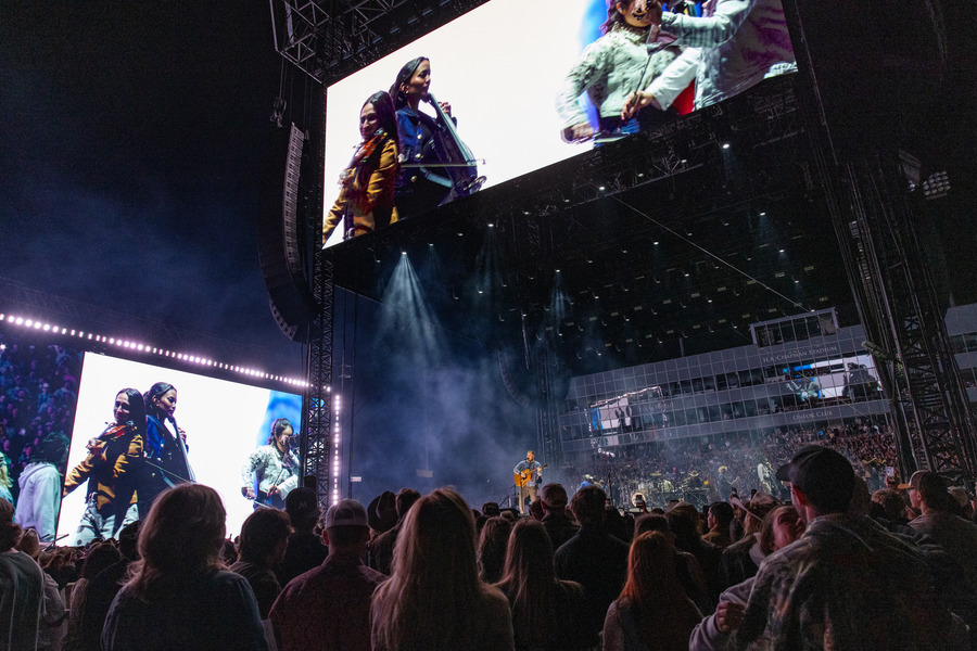 Zach Bryan performs on stage at 2026 concert, large screens above.