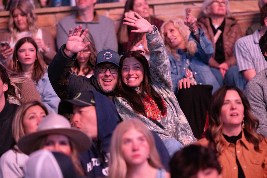 Fans waving at a Zach Bryan concert in 2026.