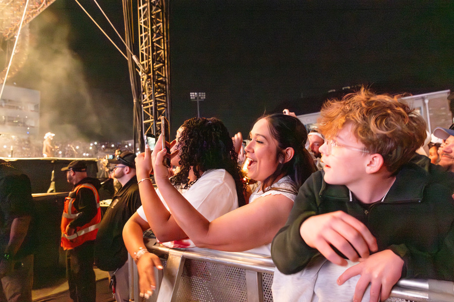 Excited fans at a Zach Bryan concert.