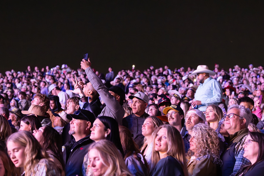 Large crowd of people at a Zach Bryan concert, many looking at the stage.