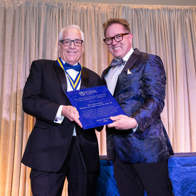 Judge William D. LaFortune Sr. and Interim Dean Marc Roark posing with an award
