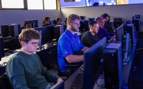 Engineering students in a computer lab at the University of Tulsa, working on AI degree coursework.