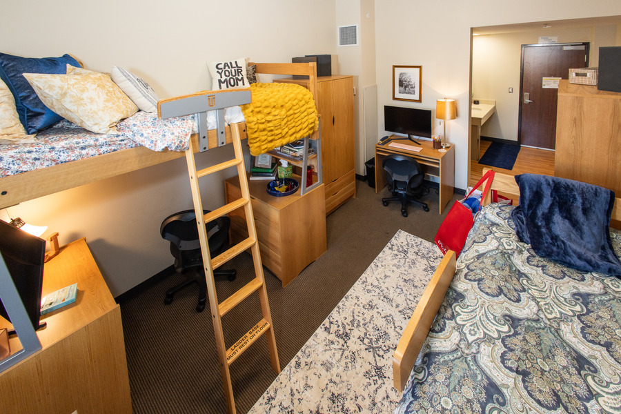 Hardesty Hall dorm room with lofted bed, desks, and closet.