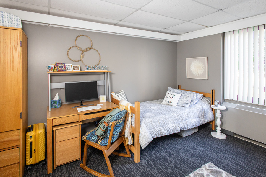 Lottie Jane Mabee Hall dorm room with bed, desk, and personal decorations.