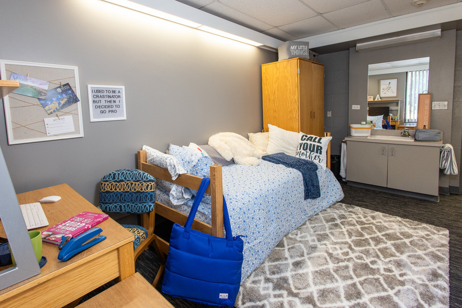 Lottie Jane Mabee Hall dorm room featuring a bed, desk, and personal touches.