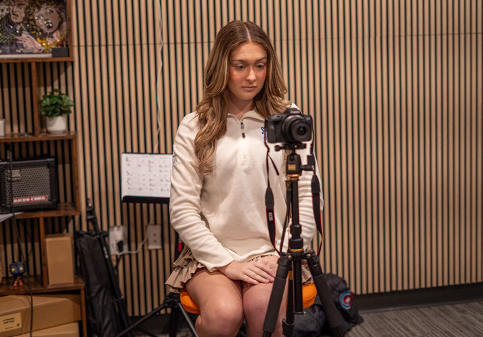 UTulsa student records a podcast episode. Camera on tripod.