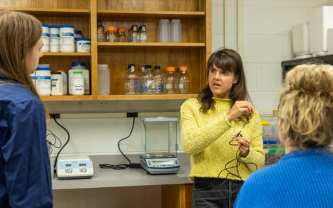 Biology lab: New faculty member explains lab equipment to students.