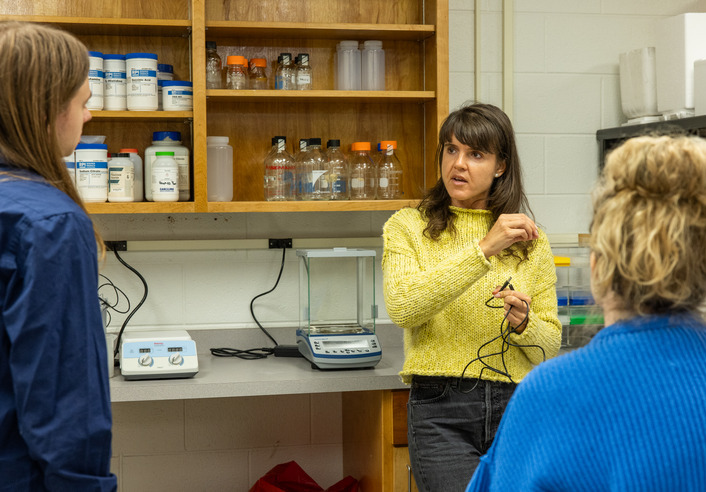 Biology lab: New faculty member explains lab equipment to students.