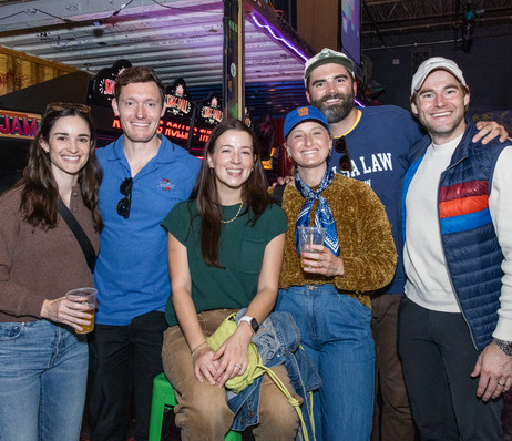 Group of six smiling UTulsa alumni at a Cane Crawl event