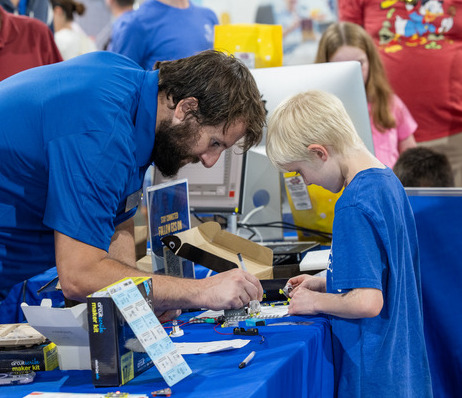 A man and a boy work on a building project at a Fab Lab Tulsa event.