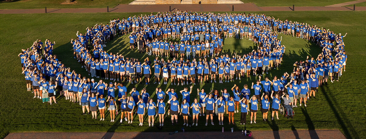 Group of students forming The University of Tulsa hurricane on Dietler Commons