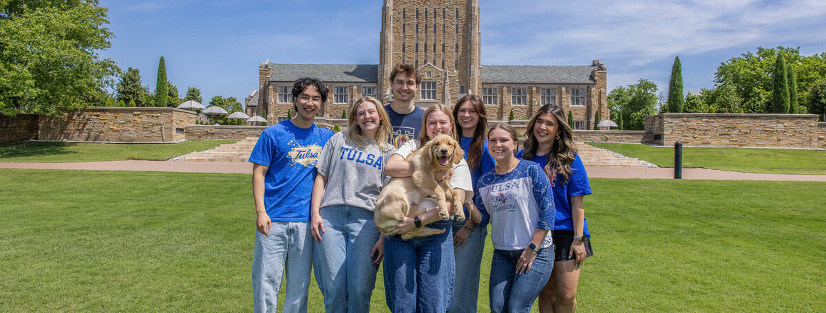 UTulsa students and Goldie pose in front of McFarlin Library