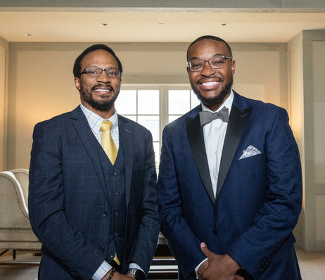Two men in suits pose for a photo at a TU Law Alumni Gala