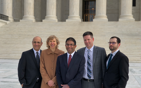 Philip Tinker stands with members of the legal team involved in Sharp v. Murphy, the predecessor case to McGirt v. Oklahoma, outside the U.S. Supreme Court following oral arguments..