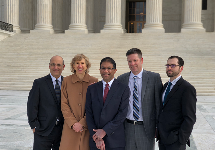 Philip Tinker stands with members of the legal team involved in Sharp v. Murphy, the predecessor case to McGirt v. Oklahoma, outside the U.S. Supreme Court following oral arguments..