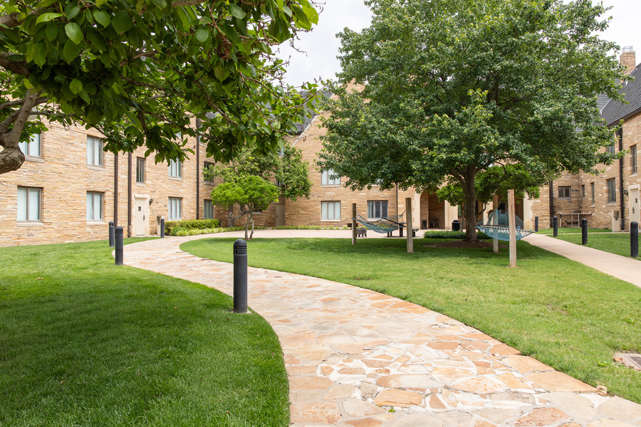 Lottie Jane Mabee Hall courtyard with stone path and hammocks