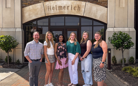 UTulsa Management Club officers and advisor in front of Helmerich Hall