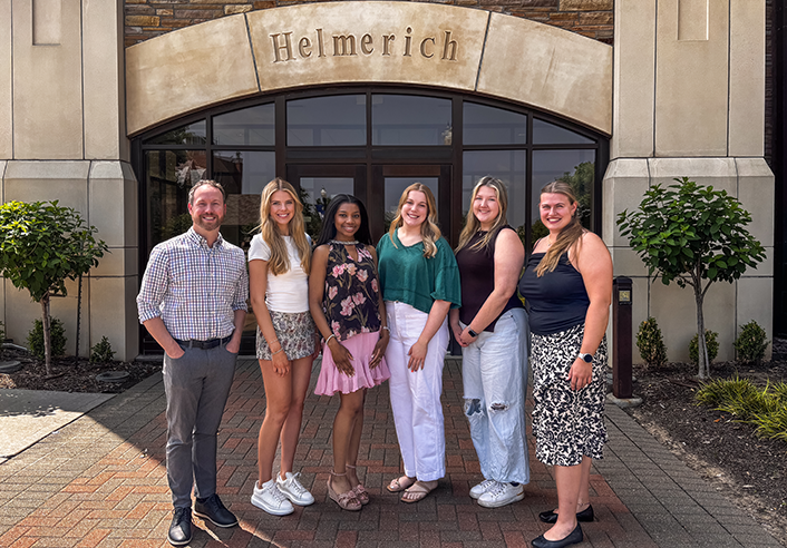UTulsa Management Club officers and advisor in front of Helmerich Hall