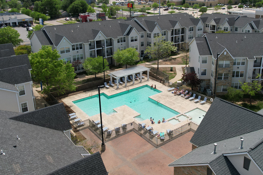Aerial view of Mayo Village apartments with a large swimming pool and lounge area.