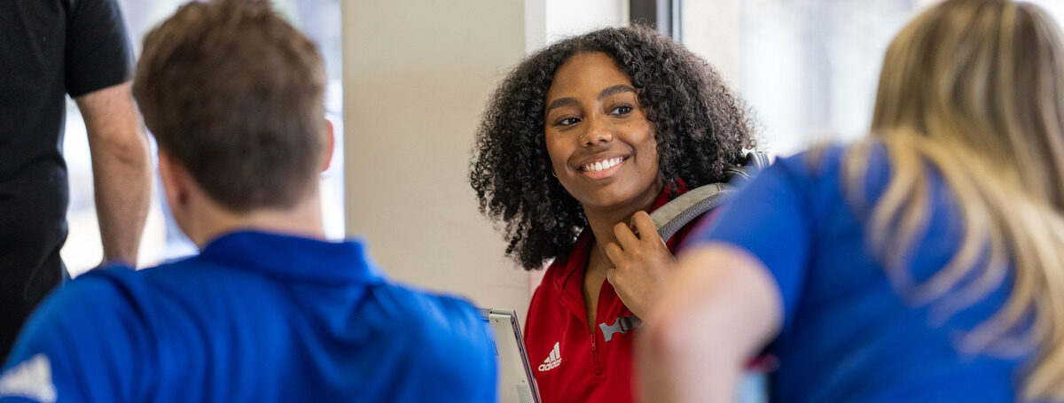 Young Black woman smiles at a 'Cane Quick Start event.