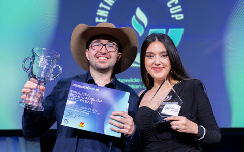 Vusal Karimov and UTulsa student at Entrepreneur's Cup, holding trophy & scholarship.