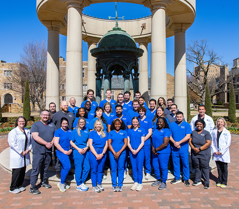 Nurse anesthesia DNP students and faculty pose in front of UTulsa's Kendall Bell