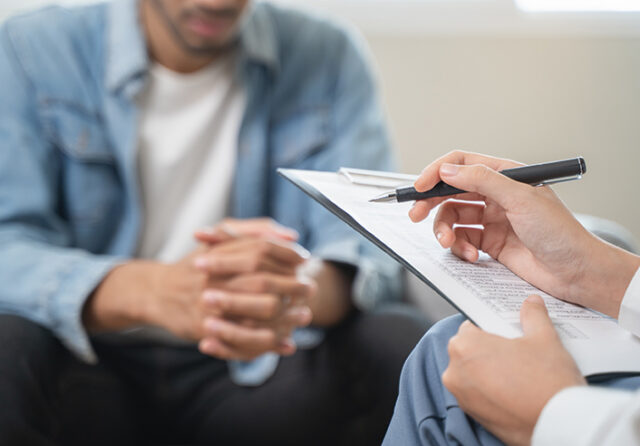 Man in blue shirt attending a counseling session