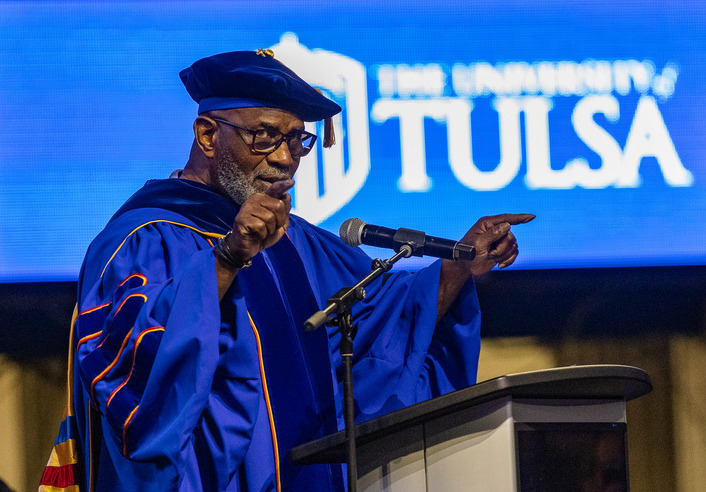 UTulsa commencement: Julius Tennon in blue academic regalia addresses graduates