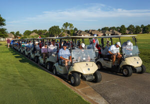 Golf carts lined up for the UTulsa Volleyball fundraiser tournament