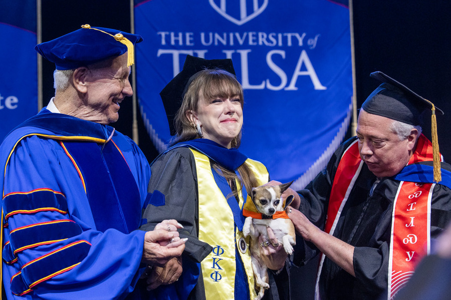 University of Tulsa graduate with chihuahua on commencement day 2026