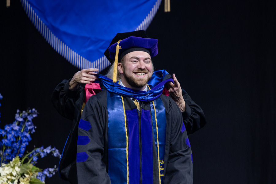 Graduate in cap and gown at commencement 2026 law ceremony