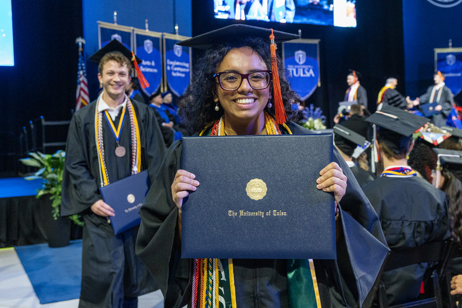 Graduate with diploma at commencement 2026