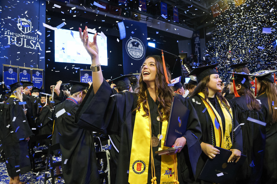 University of Tulsa graduate commencement 2026, confetti falling on happy graduates.
