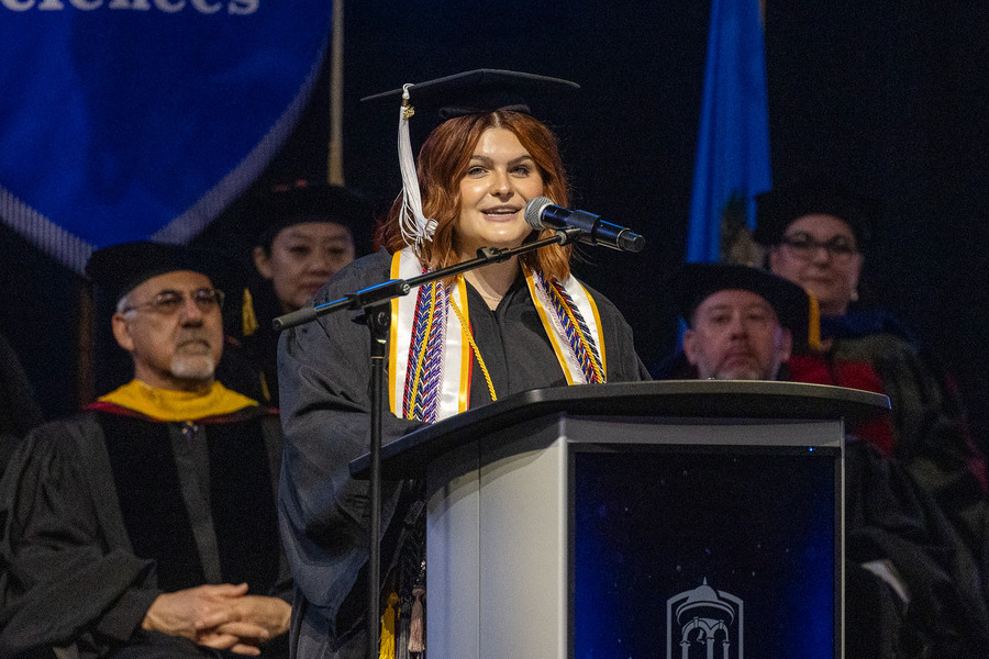 Graduate speaking at commencement 2026 podium