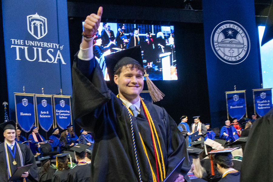 University of Tulsa graduate gives thumbs up at 2026 commencement ceremony.