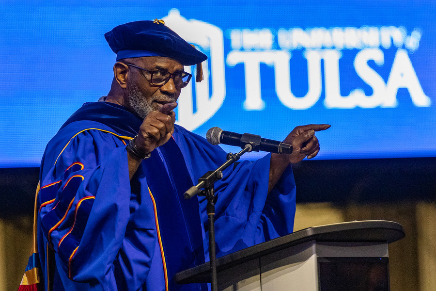 University of Tulsa commencement speaker in academic regalia points during 2026 graduation.