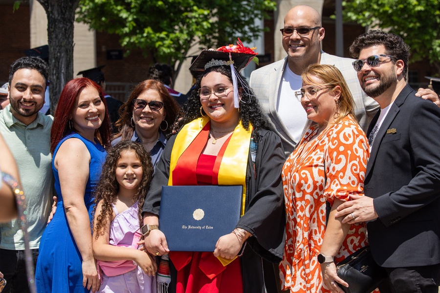 Graduate with family at commencement 2026