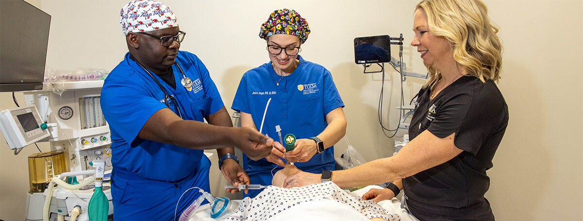 Nurse anesthesia students practice intubation on a mannequin with an instructor