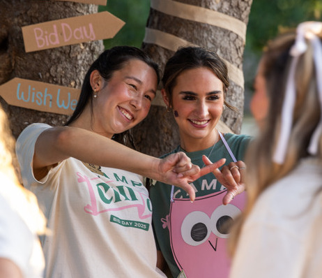 Two women in sorority shirts at Bid Day