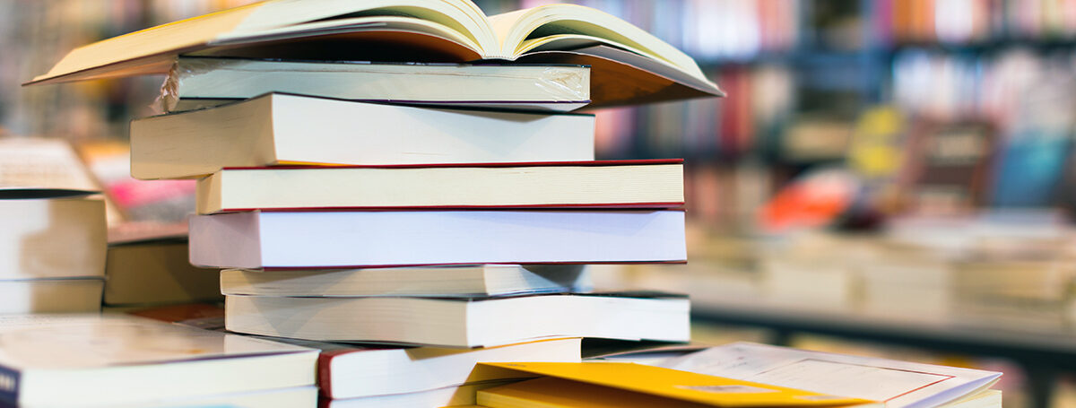 Stack of books, some open
